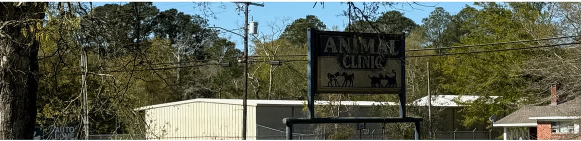 The clinic's classic roadside Animal Clinic sign on Hwy 613, with horse and cat silhouettes
